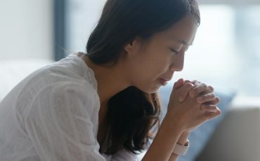 Woman pray to god at home